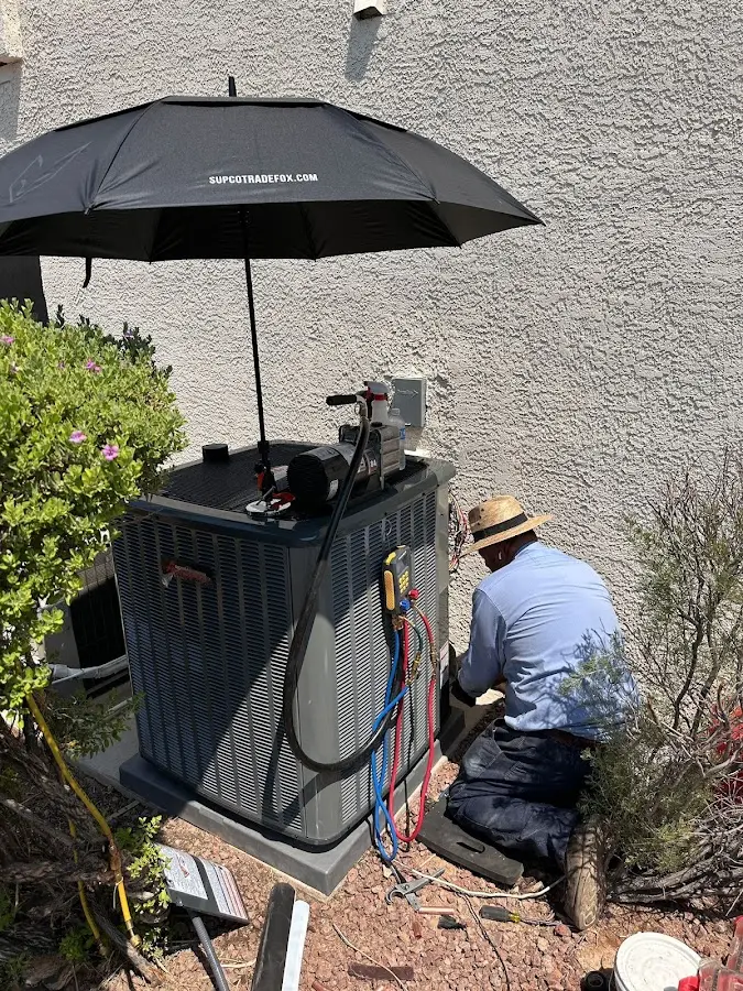 HVAC technician performing outdoor AC maintenance in Davie
